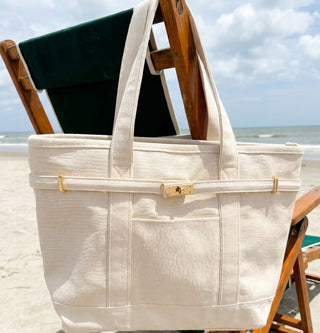 Boatkin with zipper top in solid natural hanging on a beach chair