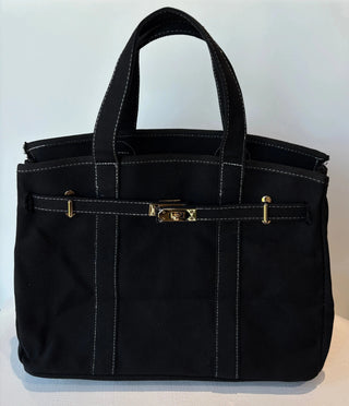 A canvas boatkin bag in solid black with white stitching