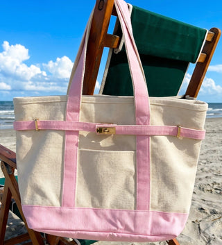 Boatkin Zipper Top Tote in pink hanging on a beach chair