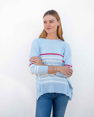 Woman in light blue & red striped sweater with heart patches