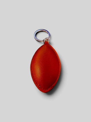 Football vegan leather charm clipped to a bag
