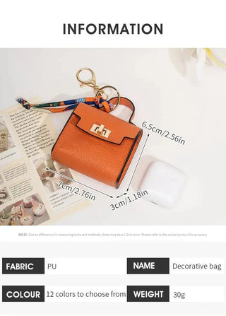 Mini handbag bag charm keychain, detail of gold turn-lock hardware and wristlet ring