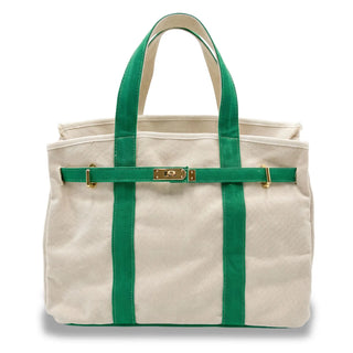A canvas boatkin tote bag in cream with vibrant green straps and trim, featuring a green front strap with gold-tone hardware, set against a plain white background.