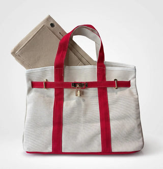 a beige boatkin bag with red straps and an insert organizer