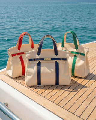 Boatkin bags in three colors on a boat deck