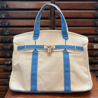 Carolina Blue Boatkin Canvas Bag on a leather chair
