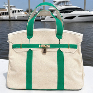 Green Boatkin canvas bag sitting on the docks overlooking the marina