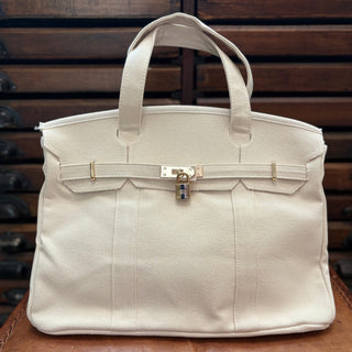 Solid natural color boatkin bag on a leather chair