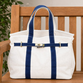 blue boatkin bag set on a teak bench