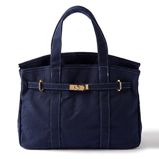 A navy blue nylon tote bag with double top handles, vertical stitched paneling, and a front strap closure featuring gold-tone hardware, shown on a white background.